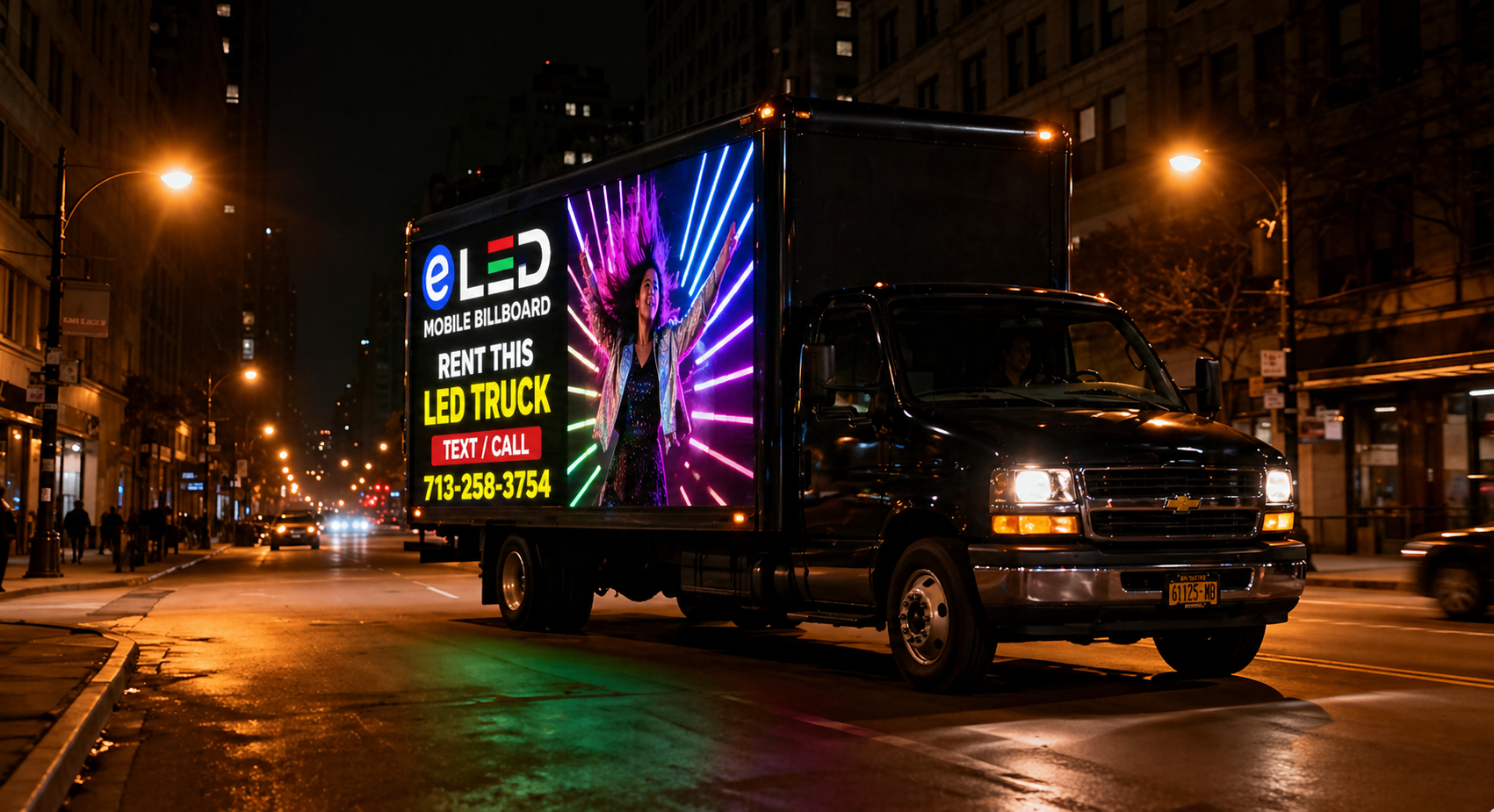 Mobile billboard truck displaying bigger brighter better at night